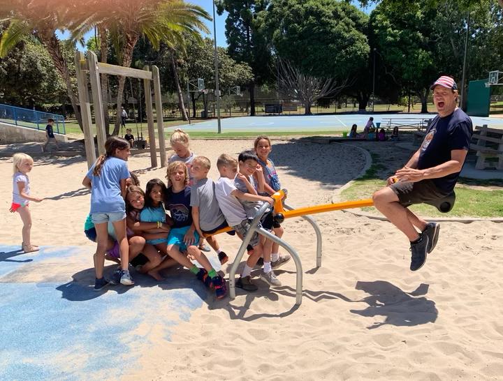 Coach Dave with kids on the playground